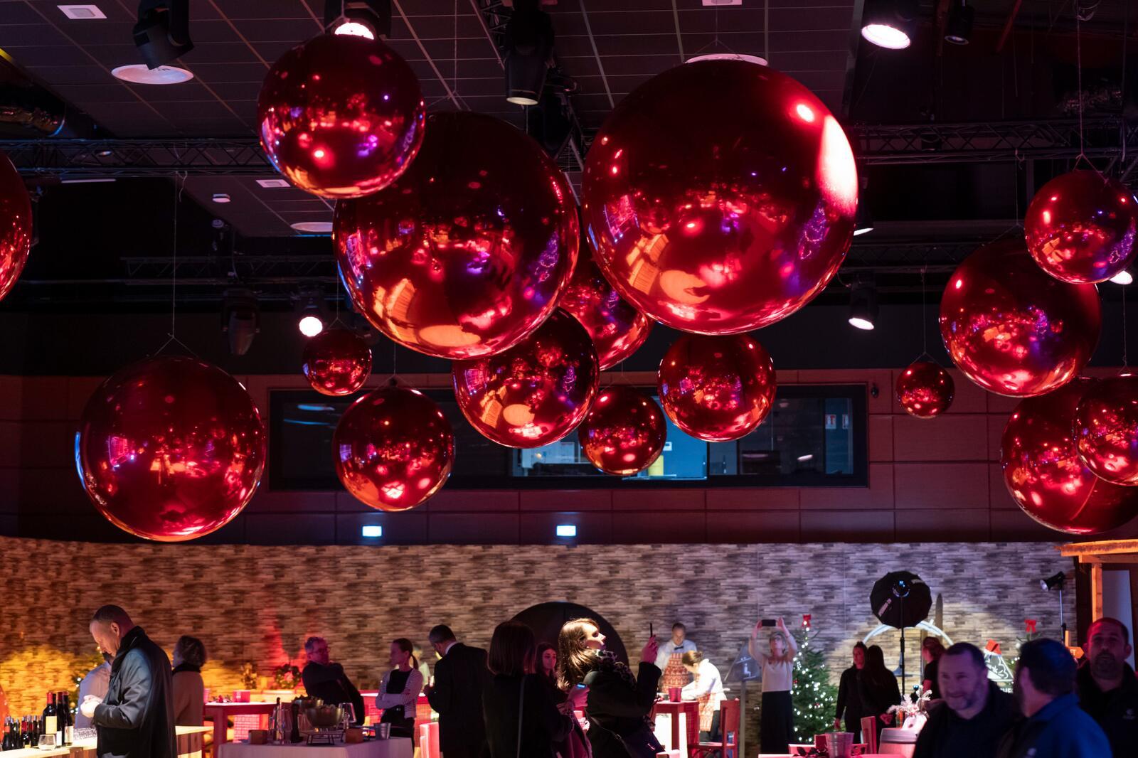 Ballons miroirs rouges suspendus lors d’une soirée d’entreprise