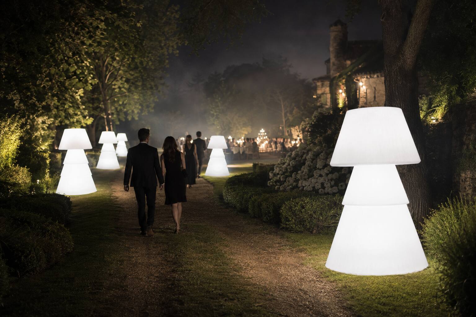 Allée de lampadaires lumineux menant à une réception dans un château